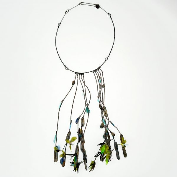 short necklace, long center of oxidized sterling silver tube beads with cool toned feathers