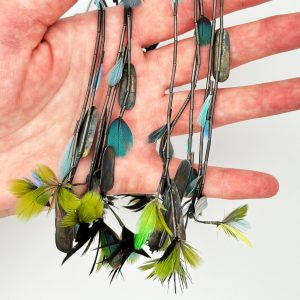 short necklace, long center of oxidized sterling silver tube beads with cool toned feathers